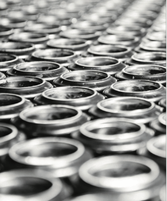 Black and white close-up of shiny aluminum can tops lined in repeating, slightly blurred rows.